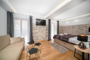 a living room with a bed and a couch at Heritage Residence in Center with pool in Vodice