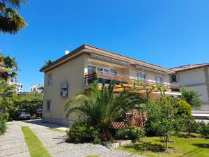 a house with a balcony on the side of it at Apartments Orange Lovran in Lovran