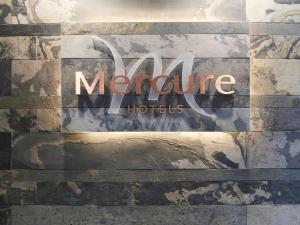 a sign for a moraine hotel on a wall at Mercure Cardiff Holland House Hotel & Spa in Cardiff