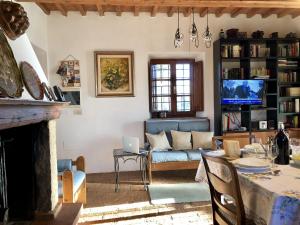 a living room with a couch and a table at Podere Morena with sea view, private terrace by ToscanaTour Greg in Guardistallo