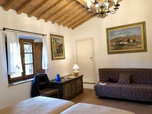 a living room with a couch and a table at Podere Morena with sea view, private terrace by ToscanaTour Greg in Guardistallo