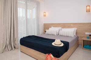 A bed or beds in a room at Aphrodite Studios & Suites