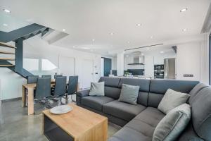 a living room with a couch and a table at Villa Corb Mari I by Sealand Villas in Muro