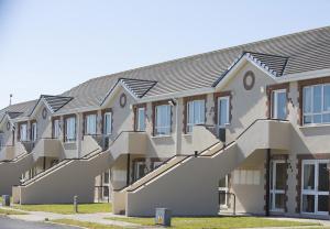 a building with stairs on the side of it at Kilkee Holiday Homes Ground Floor in Kilkee