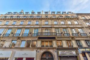 a large stone building with windows on a street at 104 - Urban Opera Lafayette in Paris