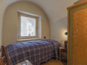 a bedroom with a bed and a window at Casa Cristina in Campitello di Fassa