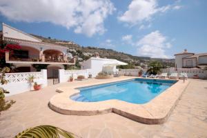 a swimming pool in the middle of a house at Holiday Home Calas in Jávea