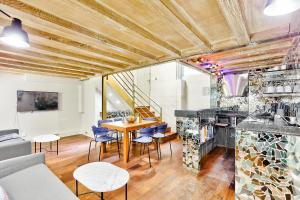 a living room with a table and blue chairs at 09 - Stylish Duplex Champs-Elysees in Paris