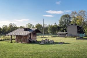 a group of animals standing in a field next to a building at La Casetta Dei Daini - Affitti Brevi Italia in Orio al Serio