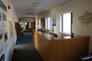 an office lobby with a reception desk and a window at Kverna Guesthouse in Skogar
