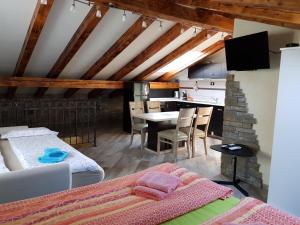 a bedroom with two beds and a dining room at Apartments Villa Irena in Koper