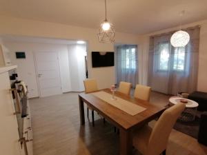 a kitchen and dining room with a wooden table and chairs at Apartments Pepe in Novigrad Istria