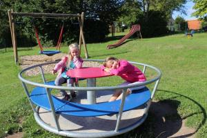 two little girls playing on a playground equipment at Sonnenhof Ottrau in Ottrau