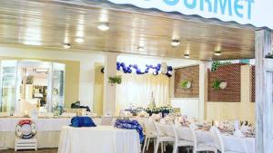 a banquet hall with white tables and white chairs at Petit gourmet in Siderno Marina
