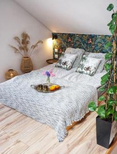 a bedroom with a bed with a tray of fruit on it at Loft Żuławy, apartament na wyłączność in Nowy Dwór Gdański