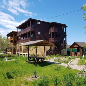 a building with a picnic table in front of it at Nika2 Hotel in Zatoka