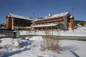 a large building with snow in front of it at La pradella Bolquere in Bolquere Pyrenees 2000