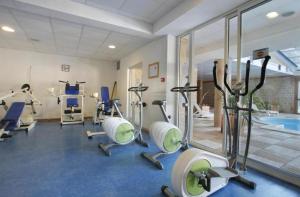 a gym with several exercise bikes and a swimming pool at La pradella Bolquere in Bolquere Pyrenees 2000