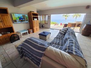 a living room with a couch and a view of the ocean at Margate Sunrise Seaview Secure Home - FAMILY ONLY, NO GROUPS in Margate