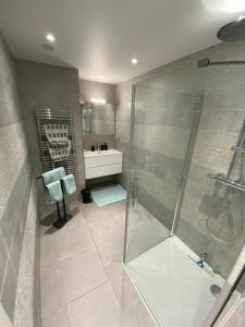 y baño con ducha y lavamanos. en Résidence Exclusive Resort, en Saint-Tropez
