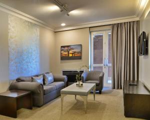 a living room with a couch and a table at ANEW Hotel Centurion Pretoria in Centurion