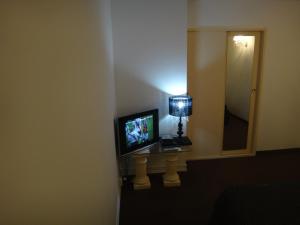 a room with a television and a mirror at Hipolito Argentina in Buenos Aires