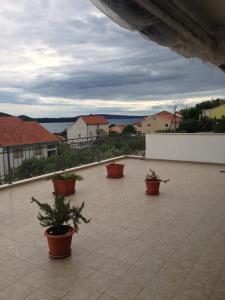 a group of potted plants sitting on a patio at Apartments Sevo in Trogir
