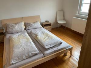 a bed with two pillows on it in a room at Ferienwohnungen Jakobsberg in Bamberg