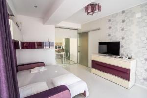 una camera d'albergo con letto e TV di Summerland Nikos Residence a Mamaia