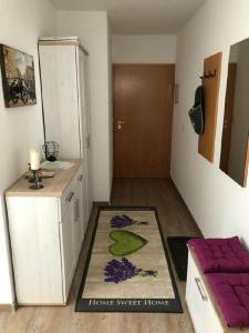 a small room with a kitchen with a rug on the floor at Ferienwohnung 32 im Ferienland Sonnenwald - Bayerischer Wald in Schöfweg