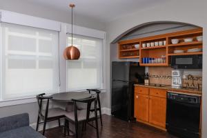 a kitchen with a table and a black refrigerator at Club Wyndham Riverside Suites in San Antonio