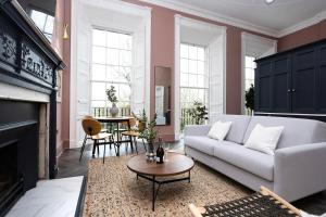 a living room with a white couch and a table at 29 Queen Street Luxury Flats in Edinburgh