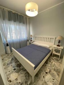 a bedroom with a large bed with a blue blanket at Alloggio Turistico Dea Bendata in Anzio