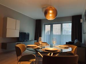 a living room with a dining room table and chairs at Dream Stay - Executive Apartment with Balcony in Tallinn