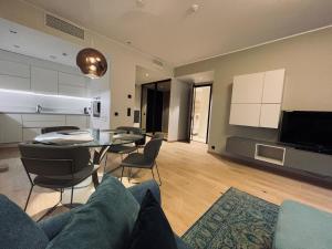 a living room with a couch and a table with chairs at Dream Stay - Executive Apartment with Balcony in Tallinn