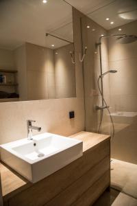 a bathroom with a white sink and a shower at Dream Stay - Executive Apartment with Balcony in Tallinn