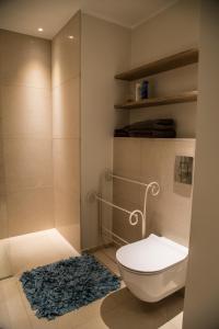 a bathroom with a toilet and a rug at Dream Stay - Executive Apartment with Balcony in Tallinn