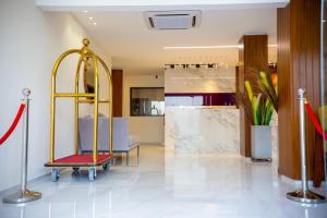 a living room with a chair and a table at Silver Moon Hotel in Abidjan