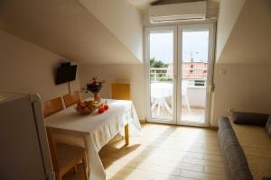 a room with a table and a view of a balcony at Sara Apartments in Makarska