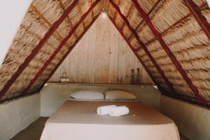 a bed with two rolls of toilet paper on it at Vila Prana in Barra Grande