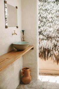 a bathroom with a bowl sink on a wall at Vila Prana in Barra Grande