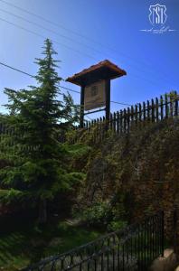 a sign on the side of a hill with a fence at Saint Michel Chalets in Al Arz