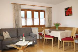 a living room with a couch and a table at Ferienwohnung Wurm in Schönau am Königssee