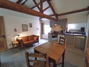 a living room with a table and a couch at Headingley Hideaway in Leeds