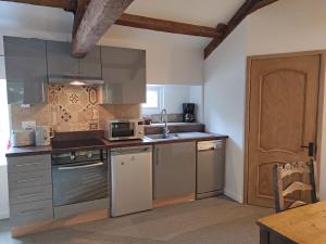 a kitchen with stainless steel appliances and a wooden door at Headingley Hideaway in Headingley