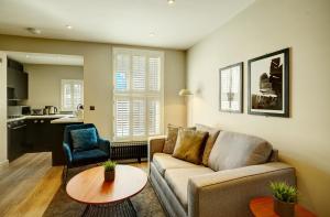 a living room with a couch and a table at 60 Manchester Road in Altrincham