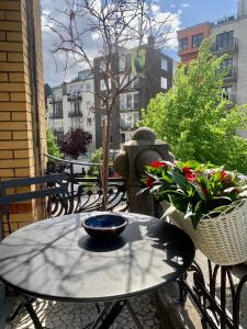 a bowl on a table on a patio with flowers at SLEEP INN - Japanese Loft with balconyview citycenter in Antwerp