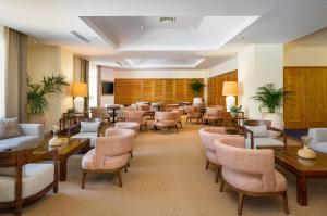 a waiting room with tables and chairs in a hospital at PortoBay Falesia in Albufeira