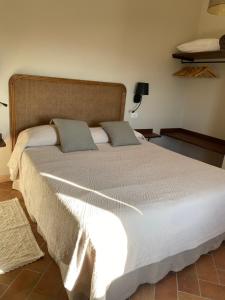 a bed with two pillows on it in a bedroom at Vitabella Toscana in Seggiano