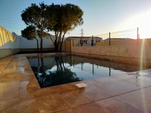 a swimming pool in the middle of a patio at FINCA VILLA ZAAR HOMES in Puerto Real